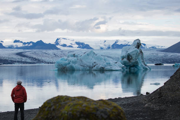 istock Lonely man is looking at a iceberg 865065658