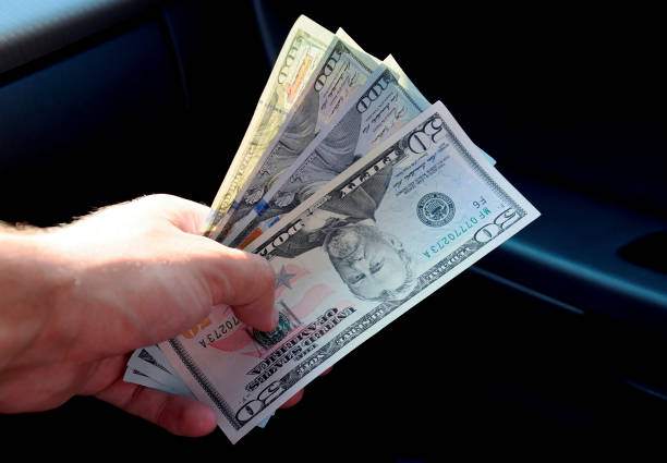 istock Hand transmitter dollars. Transferring money out of the hands. A 865067102