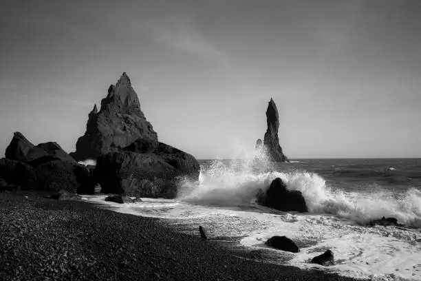 Coast of Reynisdrangar in iceland on a day with bright blue sky. Also known as blackbeach.Black and white picture.