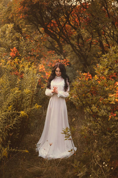 istock Beautiful brunette is walking in the autumn forest 865073140