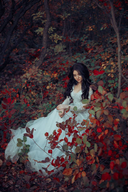istock Beautiful brunette is walking in the autumn forest 865073580