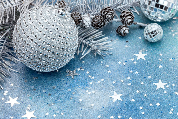 istock christmas tree branch with cones and decorations on blue background with sparkling stars 865074626
