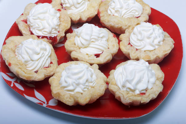 istock Cakes with cream. They lay on a plate. 865081746