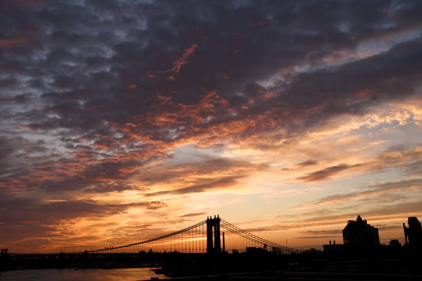Romantic sunset over Brooklyn Bridge in New York.