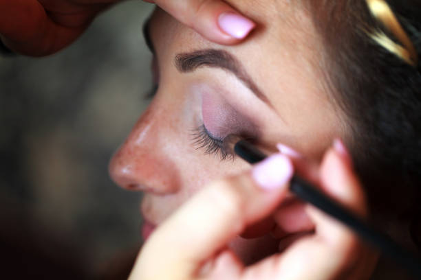 istock Wedding makeup artist making a make up for bride 865094182