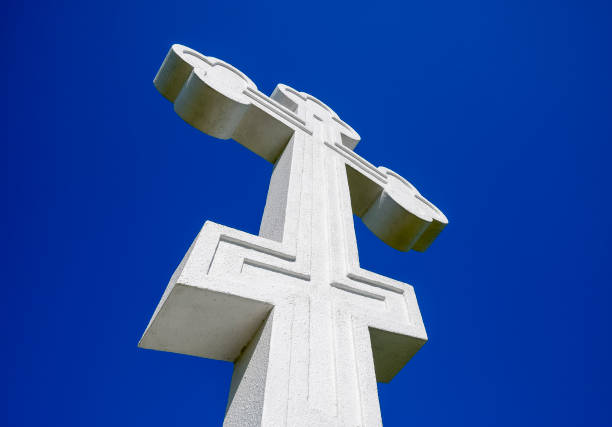 White orthodox christian cross on blue sky background