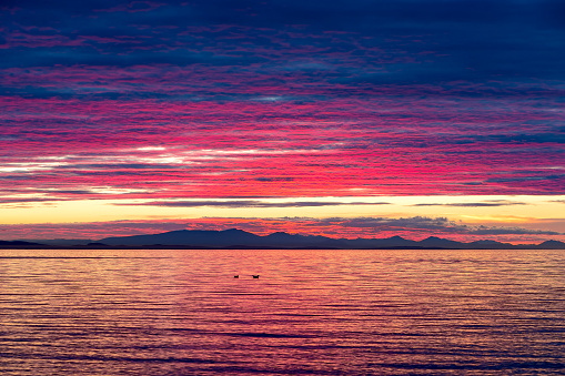 Intense dramatic sunset color over Birch Bay in Washington State USA America