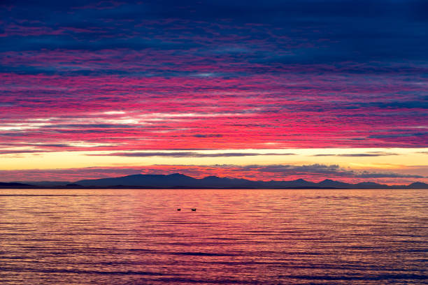 Intense dramatic sunset color over Birch Bay in WA State United States Intense dramatic sunset color over Birch Bay in Washington State USA America blaine washington stock pictures, royalty-free photos & images