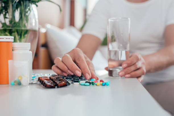 istock senior woman taking medicine 865097764