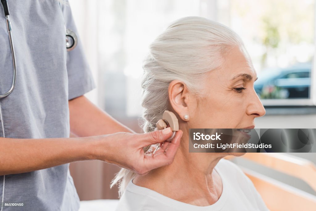 verpleegkundige en patiënt met gehoorapparaat - Royalty-free Hoortoestel Stockfoto