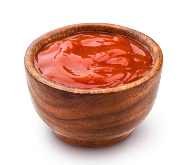 istock Ketchup in wooden bowl isolated on white background 865100674