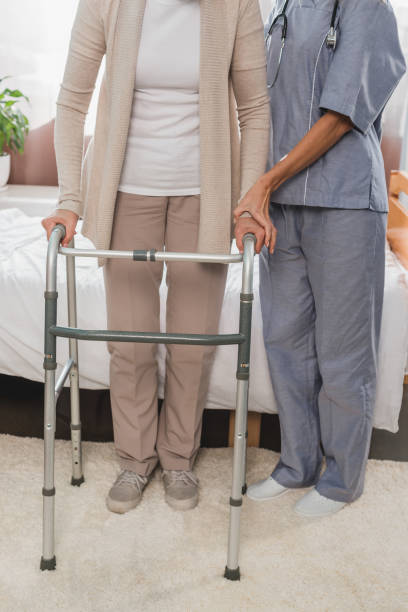 istock nurse and senior patient with walker 865101196