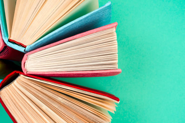 istock Top view of bright colorful hardback books in a circle. 865102904