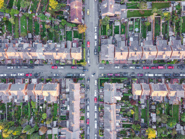 Aerial view of traditional housing suburbs cross roads in England Old fashioned British suburb cross roads taken be an drone from the air. row house photos stock pictures, royalty-free photos & images