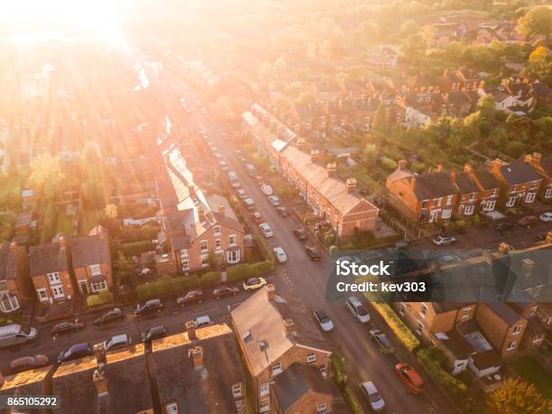 Aerial View Of The Sun Setting Over A Cross Roads In A Traditional Uk Suburb Stock Photo - Download Image Now
