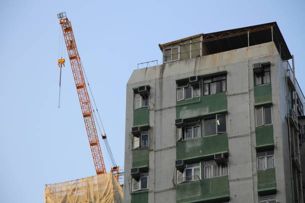 istock A crane is prominently in operation on top of a not yet complete building construction project. 865105350
