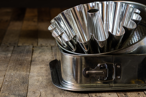 Old baking molds on an old kitchen table. Baking accessories in the kitchen. wooden table.