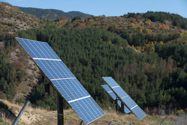 istock Solar panels with blue sky and mountains in the background. 865111582