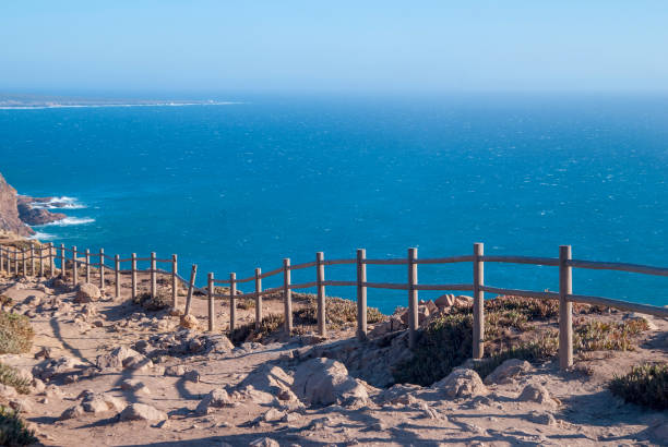 istock View od Cabo da Roca in Sintra - Roca Cape - cliffs and fence at sunset 865114986