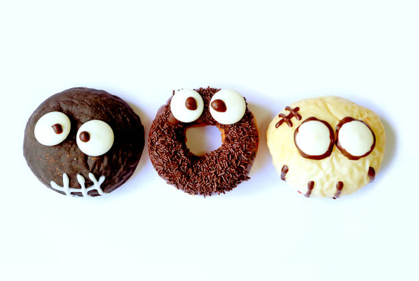 istock Top View of Ghost shaped and Monster Shaped Doughnuts for Halloween 865125220