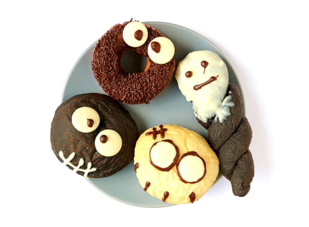 istock Halloween Ghosts and Monsters Shaped Doughnuts Served on the Plate 865125254