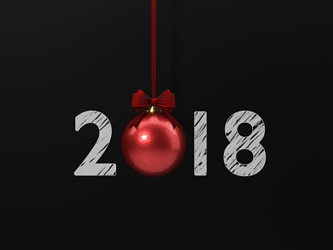 Red Christmas bauble tied with red velvet ribbon over blackboard. 2018 writes on blackboard. Horizontal composition with copy space. Great use for Christmas related concepts.