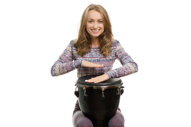 istock Beautiful girl plays the djembe 865126098
