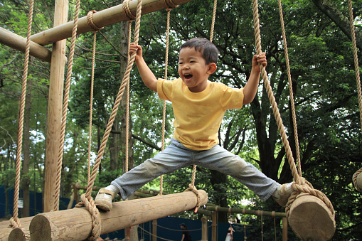 Japanese boy playing at outdoor obstacle course (3 years old)