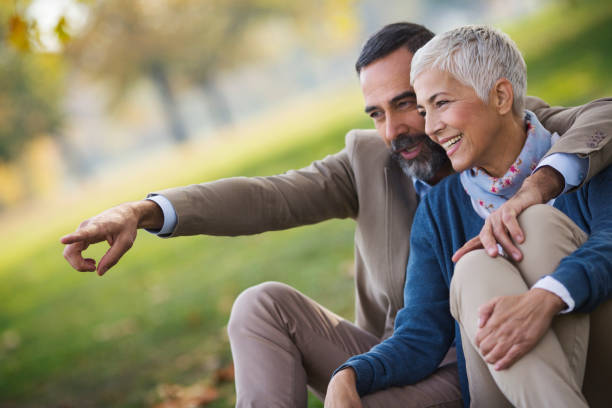istock Mid aged couple in a park 865129580