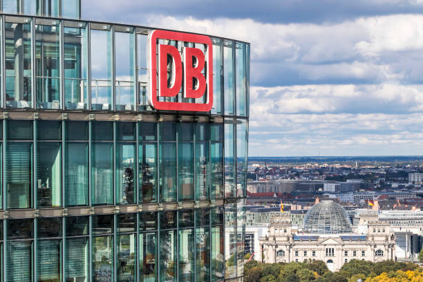 DB Logo on the top of BahnTower in Berlin, Germany Berlin: DB Logo on the top of Bahn Tower. It's a 26-story, 103m skyscraper on Potsdamer Platz in Berlin, Germany. Office space for the German Railway (Deutsche Bahn) HQ deutsche bahn stock pictures, royalty-free photos & images