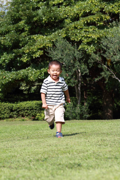 istock Japanese boy running on the grass (3 years old) in summer 865129930