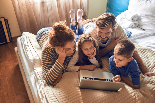 young family having fun using laptop together