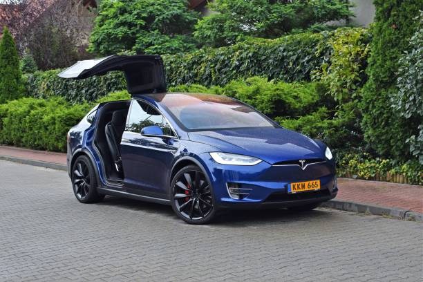 Tesla Model X on the street Poznan, Poland - 13 September, 2017: Tesla Model X parked on the street. This model is the first SUV from Tesla brand. The electric Model X has all-wheel drive and seating for seven adults. elon musk stock pictures, royalty-free photos & images