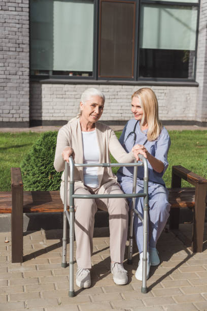 istock nurse and senior patient with walker 865132896