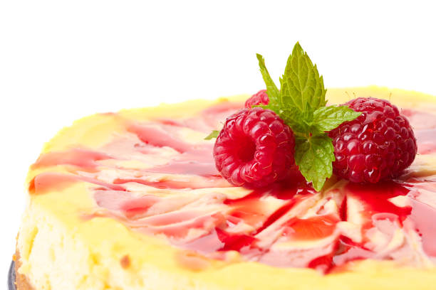 Homemade cheesecake decorated with raspberries and mint leaves
