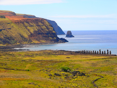 Impressive Easter Island - Rapa Nui ancient civilization -  Moai statues in Idyllic countryside and pacific ocean waves at coastline shore, dramatic landscape panorama – Chile