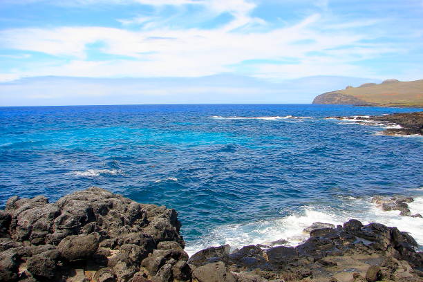 istock Impressive Easter Island and dramatic coastline shore: blue waves splashing on the rocks formation cliffs - Rapa Nui ancient civilization -  Idyllic pacific ocean at dramatic sunset, dramatic landscape panorama – Chile 865143482