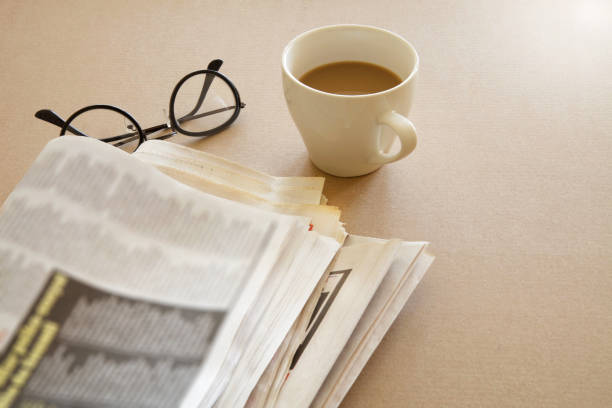 istock Newspaper with coffee on brown background 865149522
