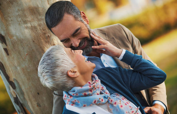 istock Mid aged couple in a park 865149914
