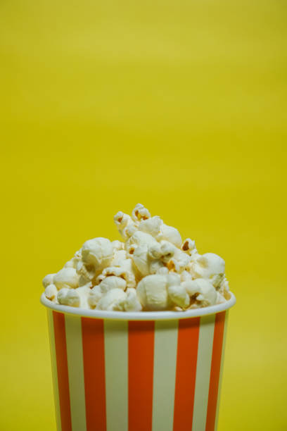 istock The popcorn which was in the paper cup（Background yellow, Simple material） 865152792