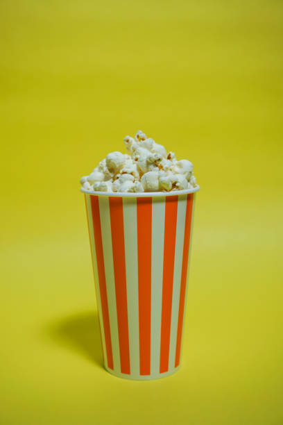 istock The popcorn which was in the paper cup（Background yellow, Simple material） 865152798