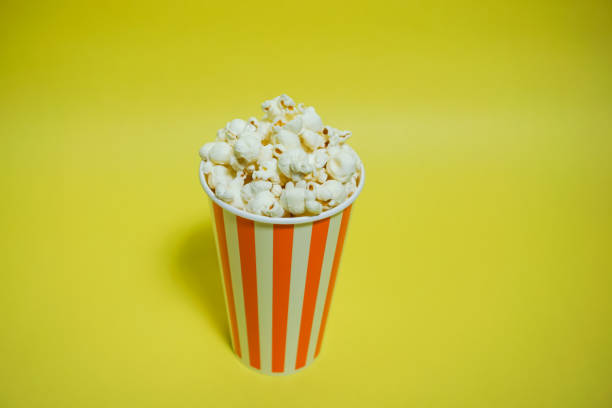 istock The popcorn which was in the paper cup（Background yellow, Simple material） 865152812