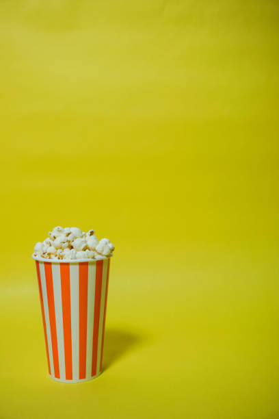 istock The popcorn which was in the paper cup（Background yellow, Simple material） 865152816