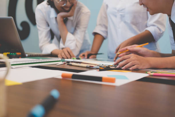 istock interior designer working with graphic tablet at workplace. artist discussing design and idea at office. business people brainstorming for new creativity project. teamwork, partnership 865154256
