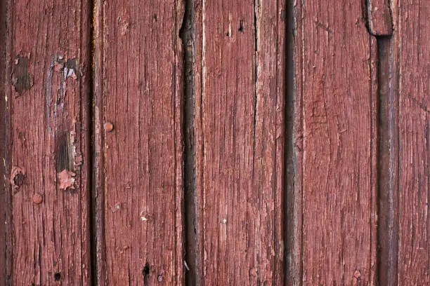 Old wood with red paint. Vertical.