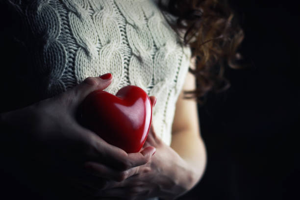 istock Hands female heart breast 865159870