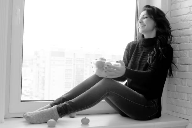 istock Girl at the window black and white 865160004