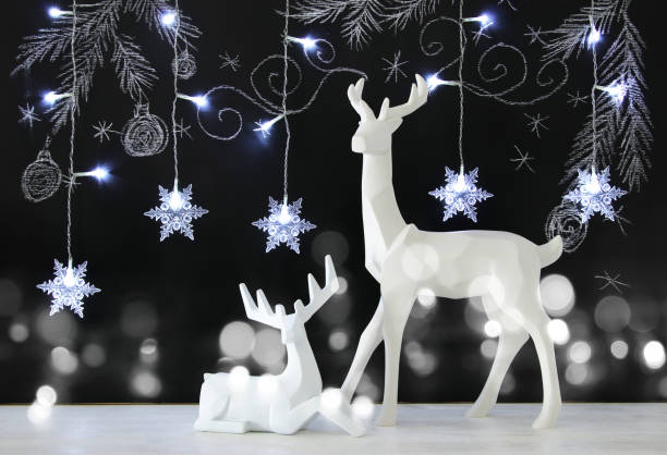 istock White reindeer on wooden table over chalkboard background with hand drawn chalk illustrations. 865163042