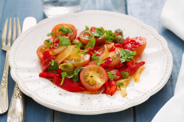 istock salad with tomato, red pepper and capers on plate 865163414
