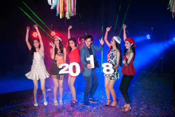 group of people dancing at night club with santa hat christmas holidays party. - political party concepts glamour friendship imagens e fotografias de stock